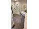 Elegant bathroom featuring double sinks, herringbone floors, a soaking tub, and a frameless glass shower at 251 Merrell Rd, Carrollton, GA 30116