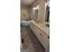 Elegant bathroom featuring double sinks, quartz counters, herringbone floors, and a soaking tub for ultimate relaxation at 251 Merrell Rd, Carrollton, GA 30116