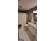 Charming bathroom featuring hexagon tile floors, white vanity, and a shower with a bright white curtain at 251 Merrell Rd, Carrollton, GA 30116