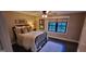 This cozy bedroom features a full-sized bed, ceiling fan and a window overlooking the natural beauty of the outdoors at 251 Merrell Rd, Carrollton, GA 30116