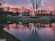 Picturesque country home reflected in a serene pond at sunset at 251 Merrell Rd, Carrollton, GA 30116