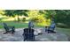 Outdoor entertaining space featuring a stone fire pit and Adirondack chairs for relaxing evenings at 251 Merrell Rd, Carrollton, GA 30116