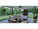 Outdoor patio with stone fireplace and large outdoor couch overlooking a lush backyard at 251 Merrell Rd, Carrollton, GA 30116