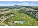 Aerial image shows neighborhood amenities, including the pool, tennis courts, and community playground, along with mountain view at 3725 Downing Dr, Cumming, GA 30040