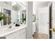 Bright bathroom with double sinks, tile floors, and an adjoining room at 3725 Downing Dr, Cumming, GA 30040