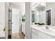 Bright bathroom featuring double sinks, large mirrors, and a doorway to another room at 3725 Downing Dr, Cumming, GA 30040