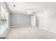 Spacious carpeted bedroom with a ceiling fan and a large window at 3725 Downing Dr, Cumming, GA 30040