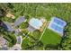 An overhead view of the neighborhood pool, tennis courts, and playground surrounded by green foliage at 3725 Downing Dr, Cumming, GA 30040