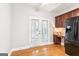 Bright dining area with hardwood floors, modern appliances, and stylish French doors at 3725 Downing Dr, Cumming, GA 30040