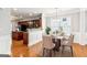 Dining area with modern lighting fixture, hardwood flooring, and wainscoting at 3725 Downing Dr, Cumming, GA 30040