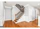Inviting entryway with hardwood floors and a staircase featuring iron spindles at 3725 Downing Dr, Cumming, GA 30040