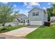 Charming two-story home with well-maintained lawn, garage, and inviting driveway at 3725 Downing Dr, Cumming, GA 30040