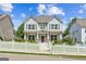 Charming two-story home features a welcoming porch and a lovely white picket fence at 3725 Downing Dr, Cumming, GA 30040