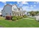 Beautifully landscaped front yard with a charming two-story home and picket fence at 3725 Downing Dr, Cumming, GA 30040