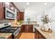 Gourmet kitchen with granite countertops, stainless steel appliances, and gas range at 3725 Downing Dr, Cumming, GA 30040