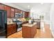 Spacious kitchen features dark cabinetry, granite countertops, stainless steel appliances at 3725 Downing Dr, Cumming, GA 30040