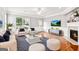 A cozy living room featuring a fireplace, wainscotting and large windows at 3725 Downing Dr, Cumming, GA 30040