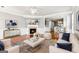 Bright living room features a fireplace, hardwood floors, and flows into the kitchen and dining area at 3725 Downing Dr, Cumming, GA 30040