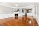 Open concept living room with hardwood floors, fireplace, and view into the kitchen at 3725 Downing Dr, Cumming, GA 30040
