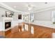 Bright and spacious living room with fireplace and rich hardwood flooring at 3725 Downing Dr, Cumming, GA 30040