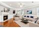 Bright and spacious living room with fireplace, hardwood floors, and modern decor at 3725 Downing Dr, Cumming, GA 30040