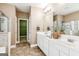 Well-lit bathroom with double vanity, decorative accents, and convenient storage space at 3725 Downing Dr, Cumming, GA 30040