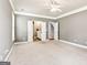 Expansive main bedroom with plush carpeting, leading to the bathroom and staircase at 3725 Downing Dr, Cumming, GA 30040