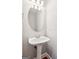 Elegant powder room featuring a pedestal sink and oval mirror at 3725 Downing Dr, Cumming, GA 30040
