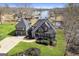 Aerial view of a gray house featuring a well-manicured lawn and lake access on a sunny day at 50 Birch Rd, Covington, GA 30014