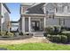 Charming home with a covered front entrance, complemented by landscaped garden beds and a view of the lake at 50 Birch Rd, Covington, GA 30014