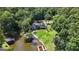 Expansive aerial view showcases a lakefront home with lush greenery and a private dock at 50 Birch Road, Covington, GA 30014