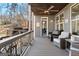 Cozy outdoor porch area with comfortable seating and a view of the lake and backyard at 50 Birch Road, Covington, GA 30014