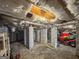 Unfinished basement with visible insulation, structural support beams, and gravel flooring at 50 Birch Road, Covington, GA 30014
