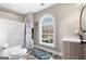 Bright bathroom featuring a stylish vanity, toilet, and a tub/shower combo with designer curtain at 50 Birch Road, Covington, GA 30014