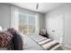 Bright bedroom featuring large window, comfortable bedding, and a cozy armchair at 50 Birch Road, Covington, GA 30014