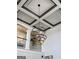 Magnificent multi-ring chandelier hanging from the beautifully patterned ceiling, adding elegance to the home at 50 Birch Road, Covington, GA 30014