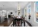 Spacious dining room featuring a stylish chandelier, seating for eight, and backyard access at 50 Birch Road, Covington, GA 30014