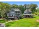 Well-maintained home exterior with a spacious deck, hot tub and stone fireplace at 50 Birch Road, Covington, GA 30014