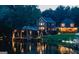 Glimmering home exterior reflecting in the lake at night at 50 Birch Road, Covington, GA 30014