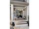 Inviting front porch featuring a rocking chair and stylish double doors, adding charm and character to the home at 50 Birch Road, Covington, GA 30014