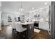 Bright, open kitchen with white cabinets, stainless steel appliances, and an island with bar seating at 50 Birch Road, Covington, GA 30014