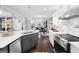 Modern kitchen with stainless steel appliances, white cabinetry, and open view to the dining area at 50 Birch Road, Covington, GA 30014