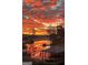 Tranquil lake view with fiery sunrise and mirrored reflections at 50 Birch Road, Covington, GA 30014