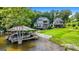 Picturesque lake view featuring a boat house and the home's beautifully landscaped shoreline at 50 Birch Road, Covington, GA 30014