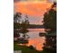 Beautiful lake view at sunset with orange and pink clouds reflecting in the calm water at 50 Birch Road, Covington, GA 30014