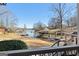 Scenic waterfront view featuring covered boat dock with lifts and natural landscape at 50 Birch Road, Covington, GA 30014
