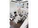 Open-concept living room with high ceilings, modern lighting, fireplace, and stylish, comfortable leather furniture at 50 Birch Road, Covington, GA 30014