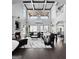 An elegant open-plan living room featuring high ceilings, a fireplace, and exquisite finishes at 50 Birch Road, Covington, GA 30014