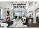 An elegant open-plan living room featuring high ceilings, a fireplace, and exquisite finishes at 50 Birch Road, Covington, GA 30014