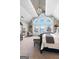 The main bedroom overlooks the water and features large windows, comfortable carpet, and a decorative chandelier at 50 Birch Road, Covington, GA 30014